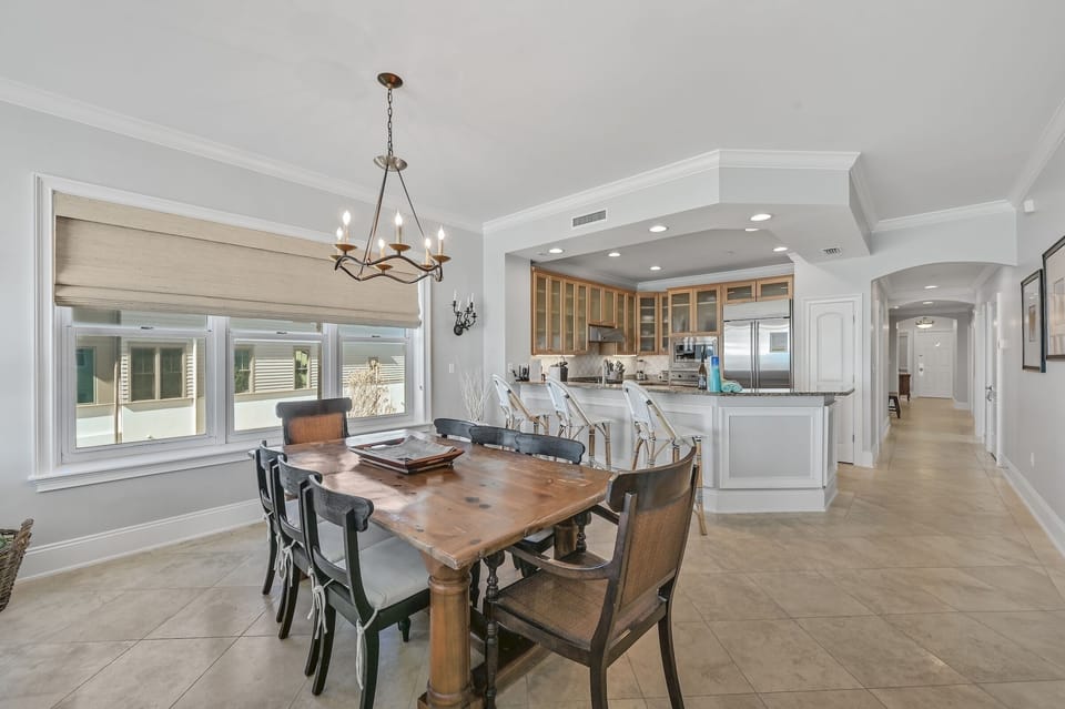 Dining Room - Gather around the dining table with seating for 8, ideal for enjoying meals together and making lasting vacation memories. With 3 additional seats at the breakfast bar.