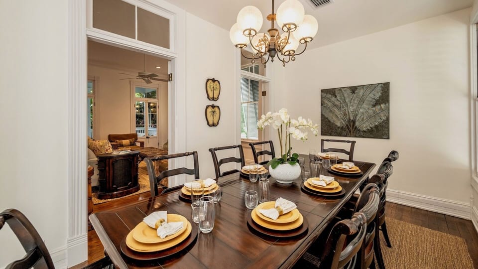 The formal dining room has a large table with seating for 8...