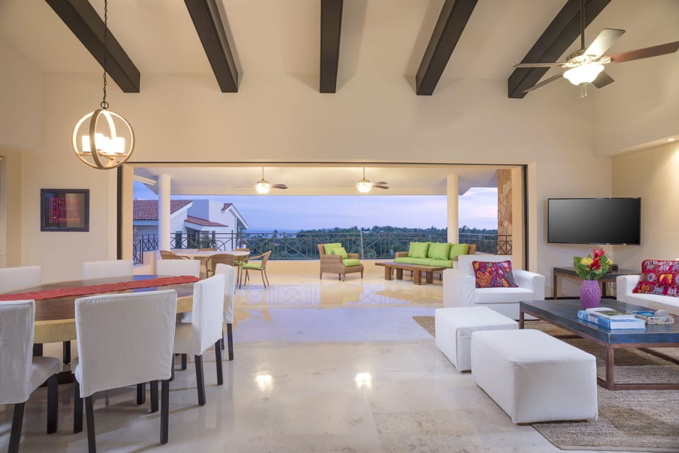 Living/dining areas open up to terrace with disappearing sliding glass doors.
