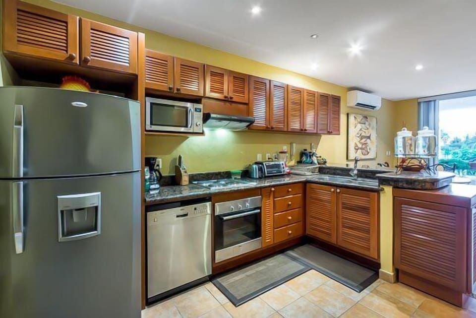 Fully-equipped kitchen with oven, stove, and small appliances