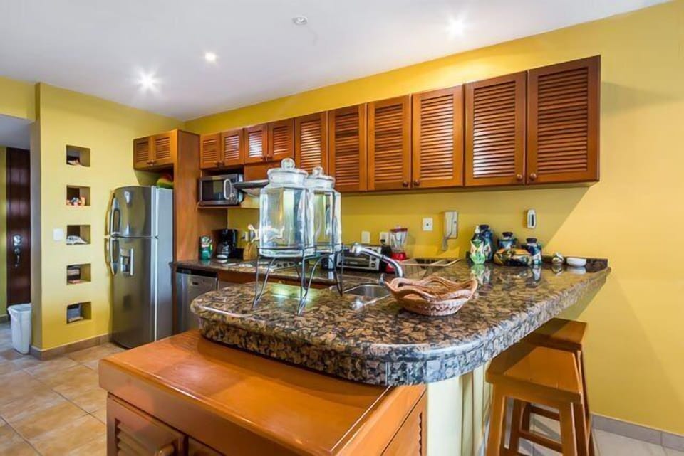 Fully-equipped kitchen with oven, stove, and small appliances