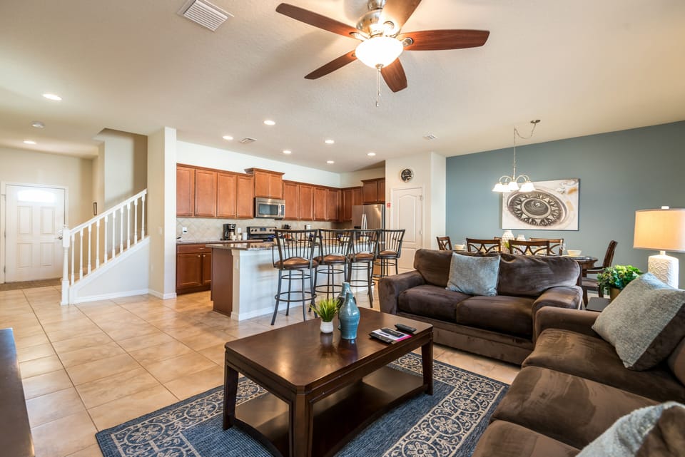 The living room and kitchen unite in perfect harmony, creating a space where comfort and functionality converge, inviting shared moments and culinary delights in a setting of contemporary elegance.