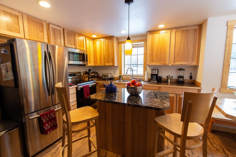 Nicely appointed kitchen with granite counter island in the center.
