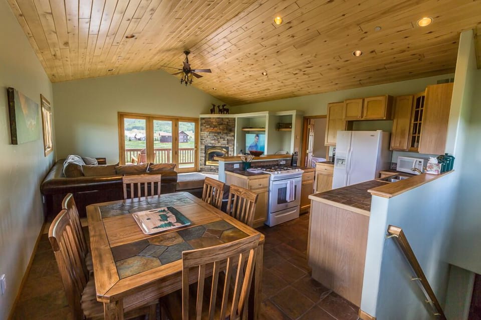 combined kitchen, dining and living room with vaulted Aspen ceilings