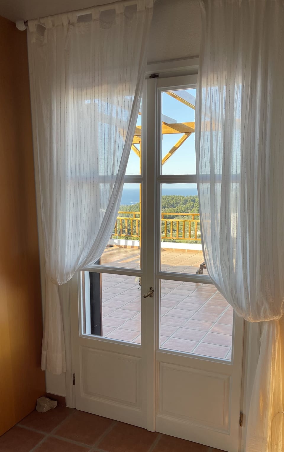 Patio doors leading to the top terrace of the upstairs master bedroom.