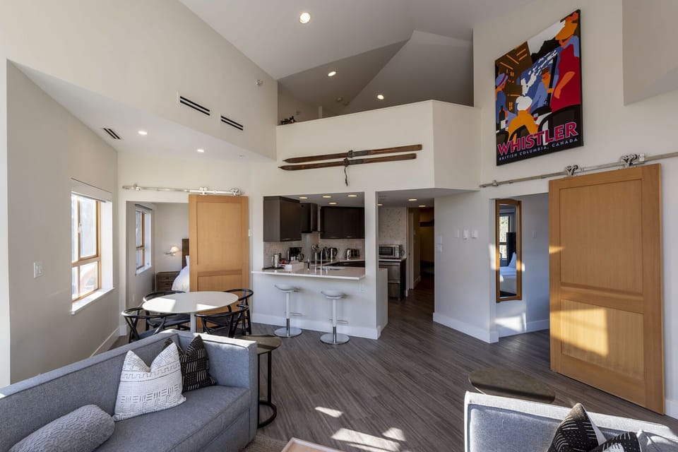 Open plan living, dining and kitchen with view to loft