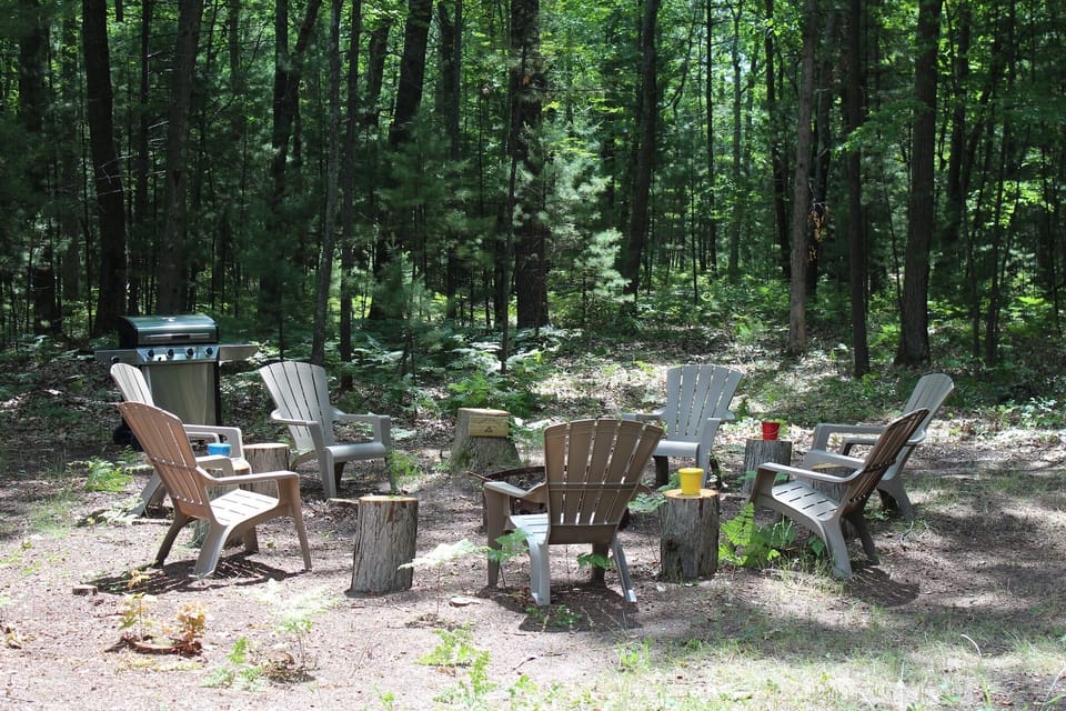 Quiet fire pit area behind the house with BBQ grill