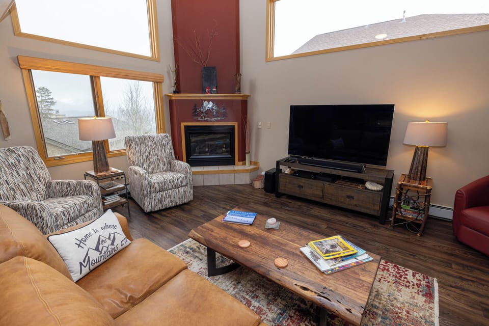 Great Room with high celings, large windows & fireplace. 65" TV and Sonos system