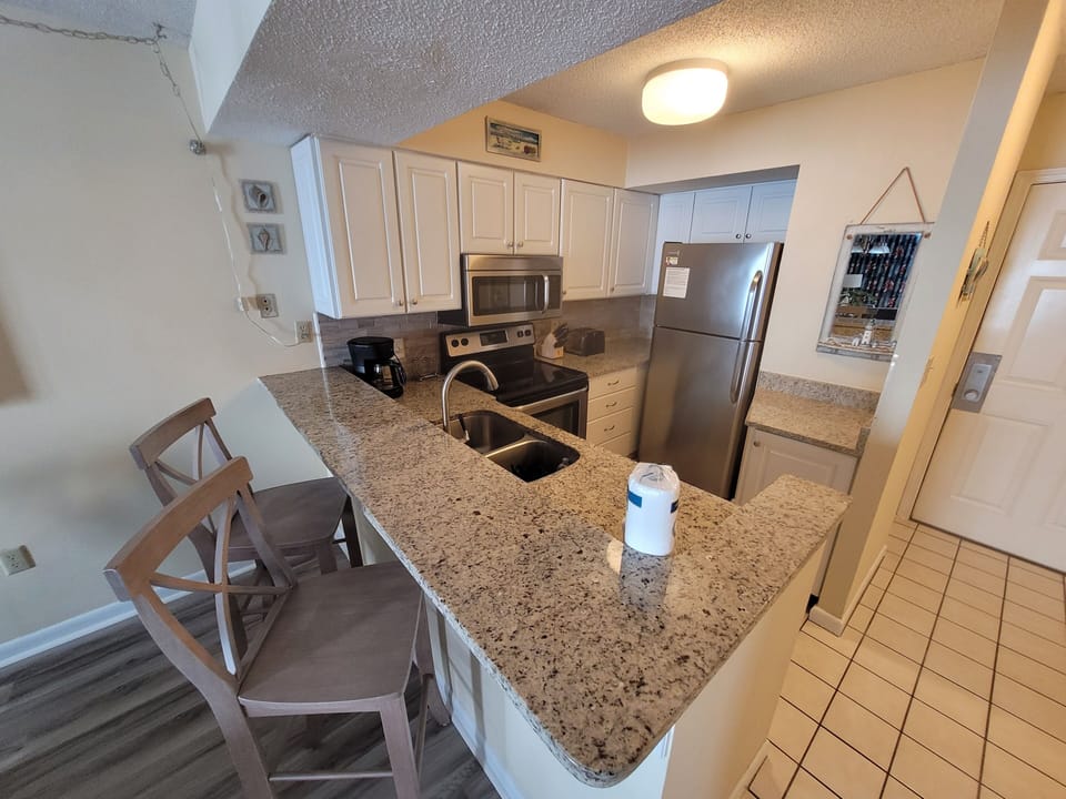 Update kitchen with granite countertops and stainless steel appliances.