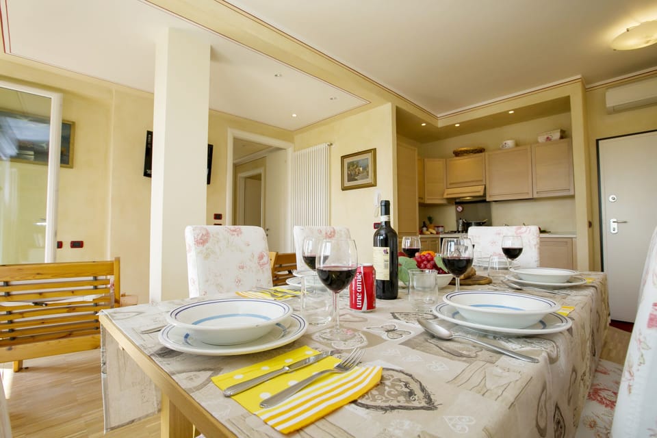 The dining area and the living room, with the open kitchen at the back