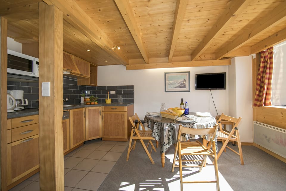 Kitchen with dishwasher and dining set