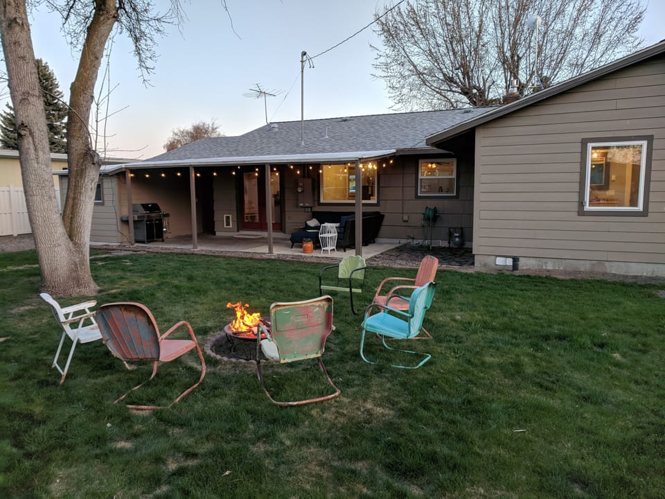 Back yard, fire pit area with lots of chairs, more than pictured.