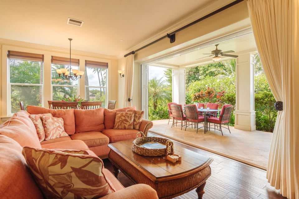Glass accordion doors allow the living room to flow out to the covered lanai