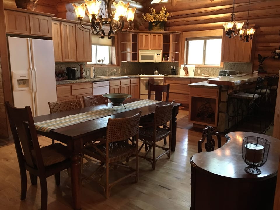 Large 7’ dinner table, additional seating at breakfast bar