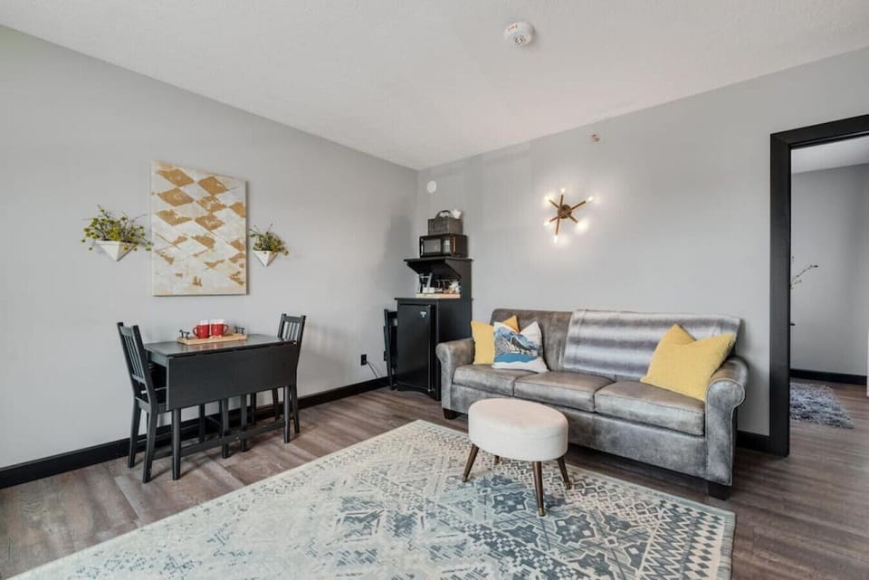 Living Room - With drop leaf table for two or four, extra folding chairs beside mini-frig, kitchenette with Keurig coffee maker, K-cups, and microwave.