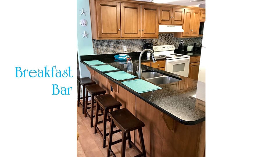 Bar seating and fully furnished kitchen.