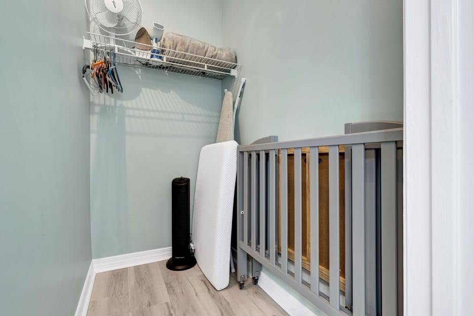 Master closet. Easy to use foldable travel crib on wheels. 