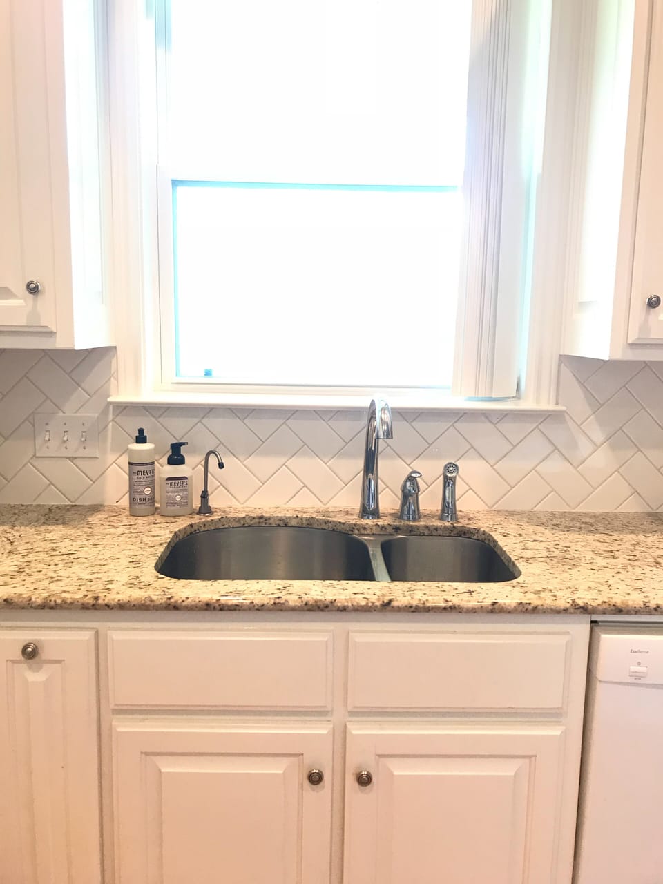 Kitchen faces large backyard.