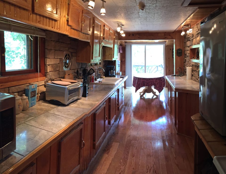 Galley Kitchen. Bathroom to back. Lake outside sliding glass doors.