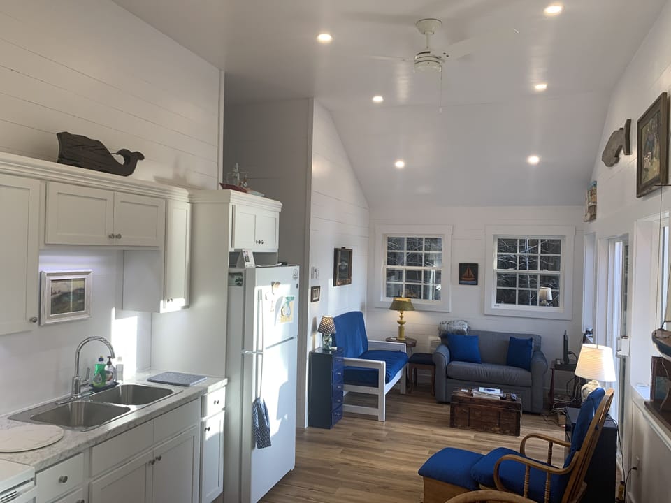 Renovated kitchen and living area with shaker style cabinets