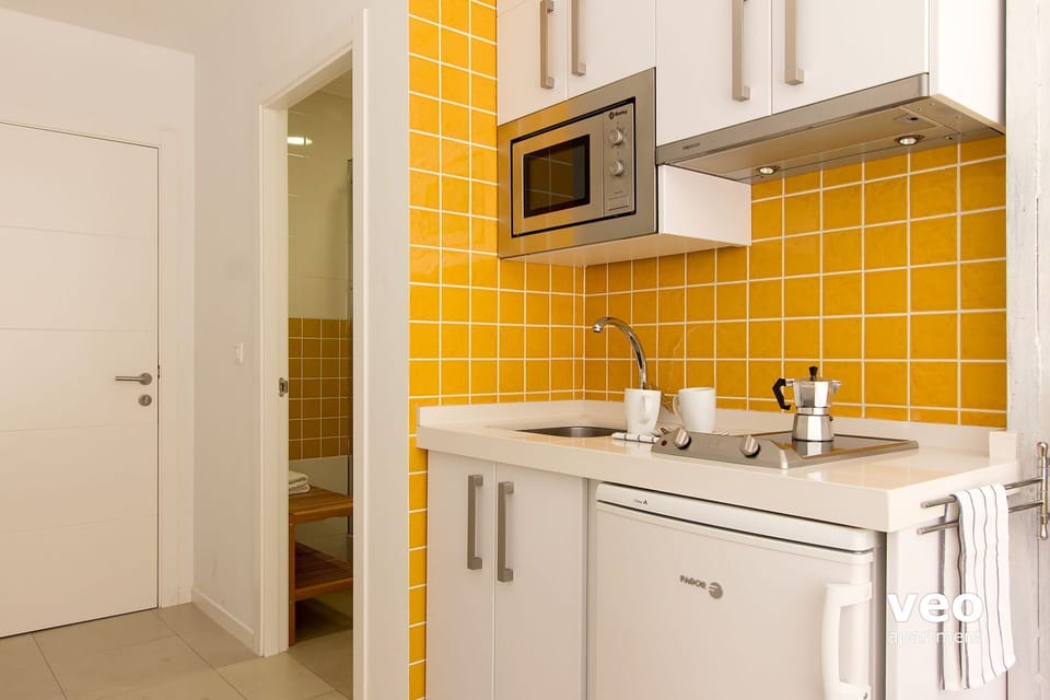 Kitchenette with utensils and appliances for self-catering.