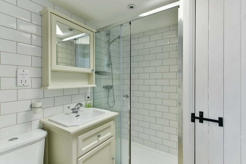 The modern bathroom is lovely and warm. It is on the ground floor.