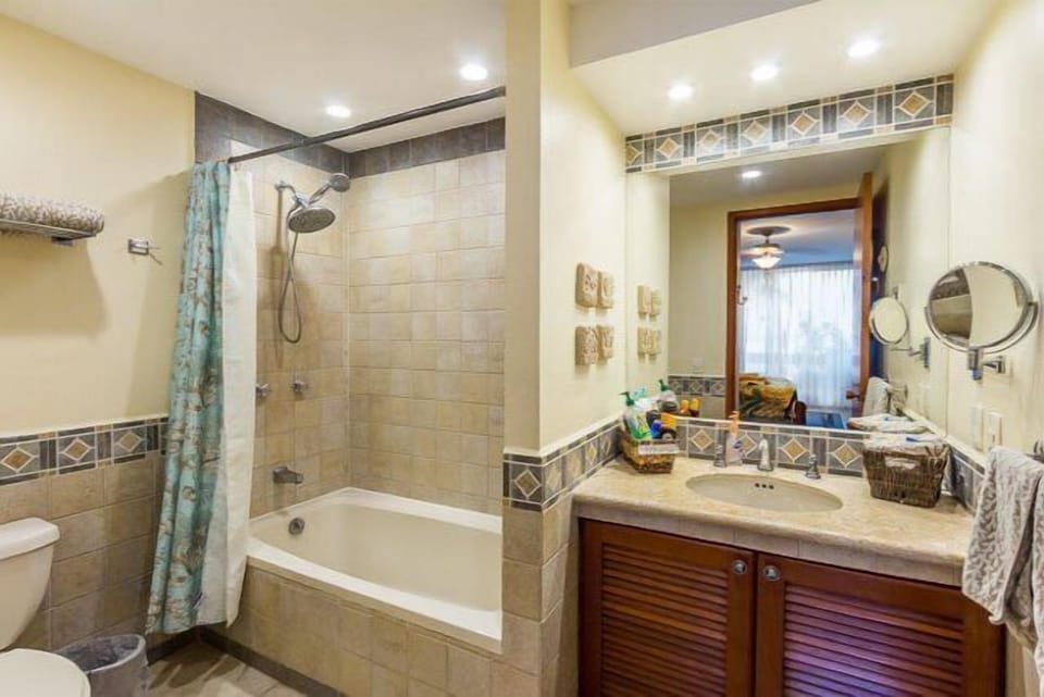 Bedroom 2 en suite bath has a tub with shower and lots of extra toiletries