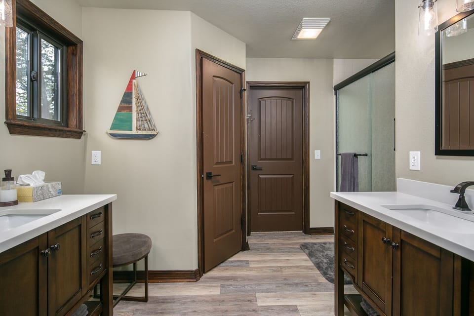 Updated master bath has 2 vanities, walk-in shower, toilet room & walk-in closet