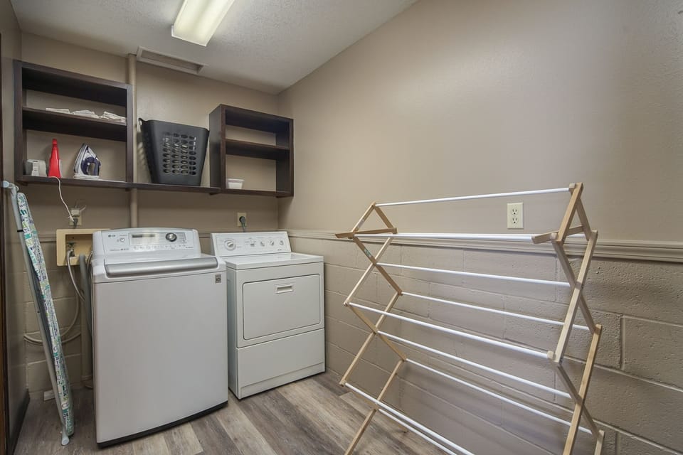 Washer and dryer, iron and ironing board, and drying rack are available.