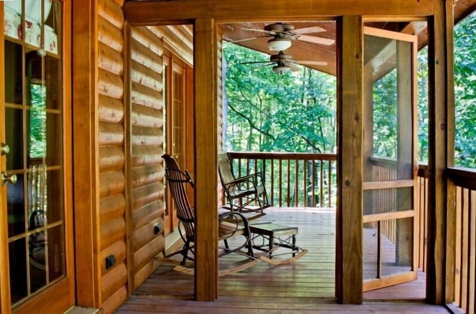 The back porch, half-screened, has 3 ceiling fans and Amish-crafted rockers.