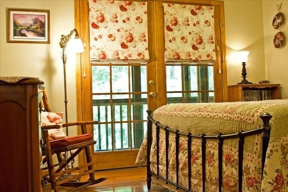 The master bedroom features a queen-size iron bed with pillow-top mattress.