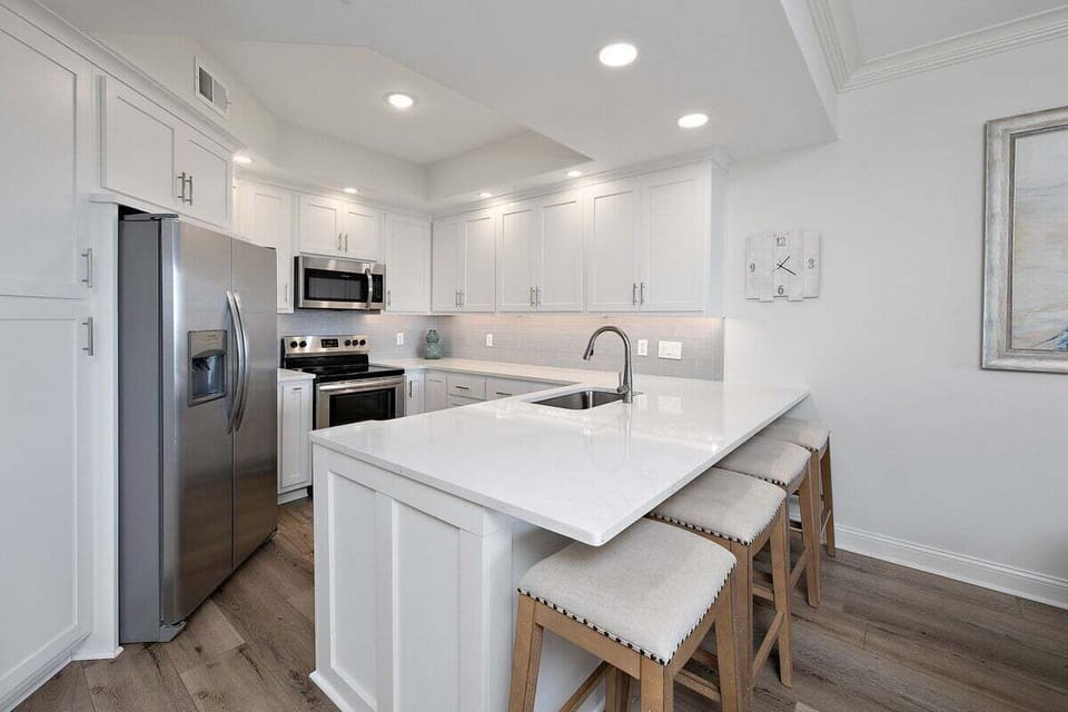 Saint Simons Grand #103 Kitchen with French Door Refrigerator, Electric Stove, and Over-the-Range Microwave