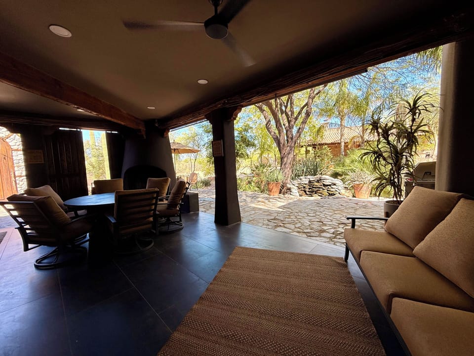 Main house patio with Fireplace, TV and Bar. 