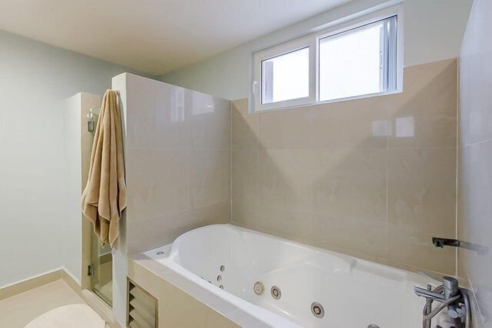 Master bathroom with double sinks, jacuzzi tub and shower
