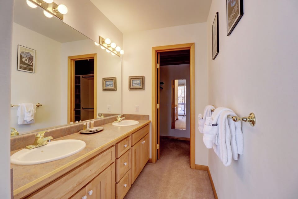 Master bathroom features double vanity sinks.
