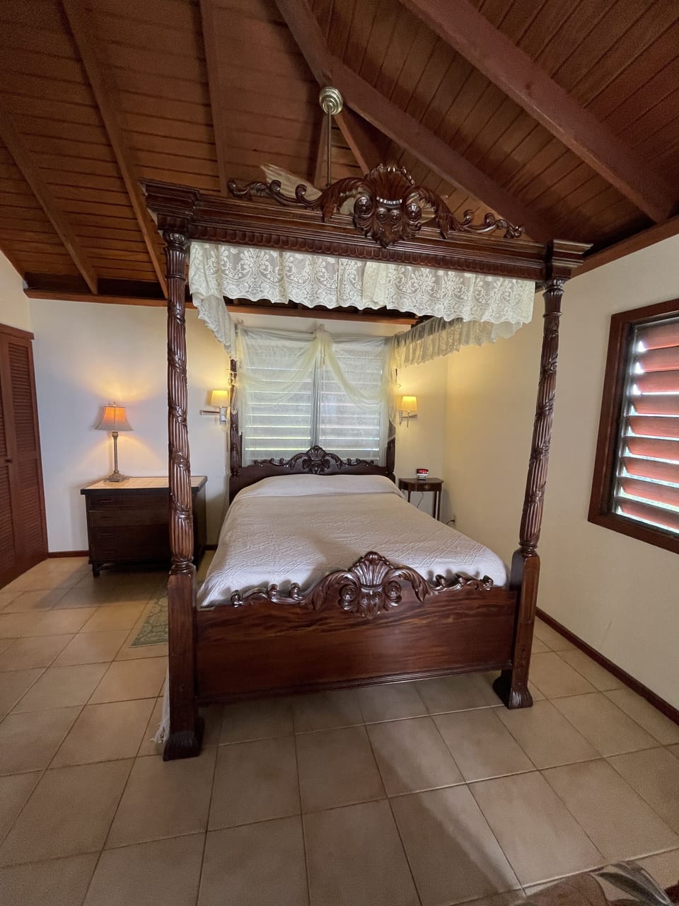Relax like royalty in the ornate Queen hand-carved mahogany 4-poster bed.