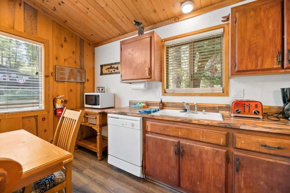 Living Room leads to bright open kitchen with gleaming floors.