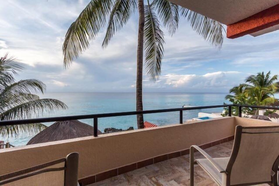 The living room terrace has ocean views and seating for watching sunsets