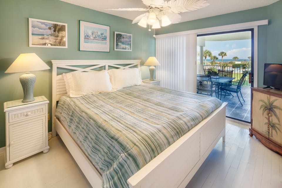 Primary Bedroom - Sleep in or wake up early and catch the sunrise from your private balcony from the primary bedroom.