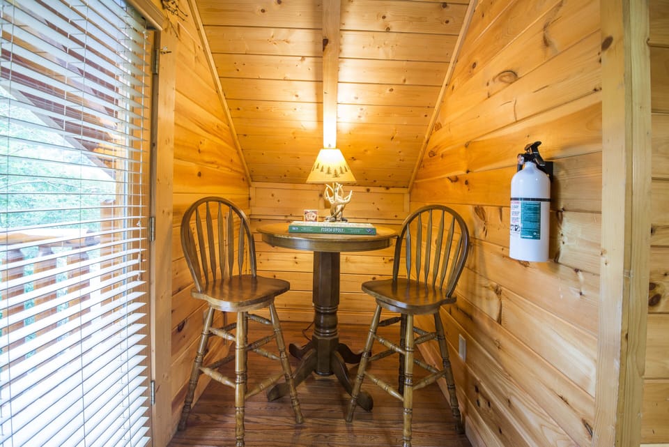 Bar top height table and chairs in loft.