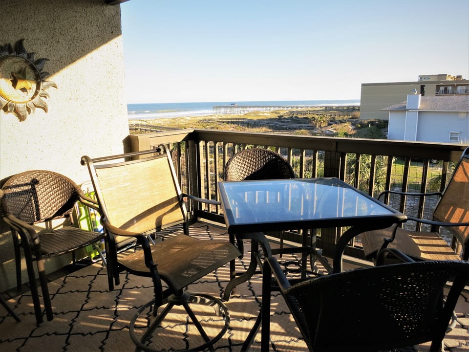 Bistro seating and table for 4 on balcony.