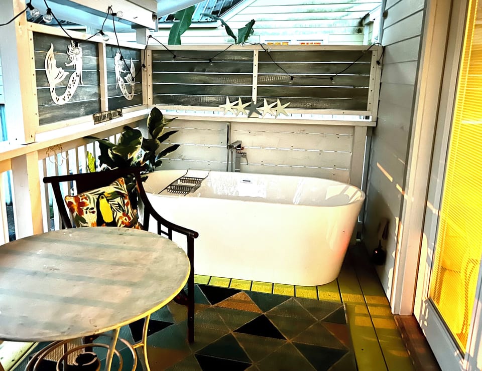 Large soaking tub on back porch with privacy fenced in yard. Perfect to relax.