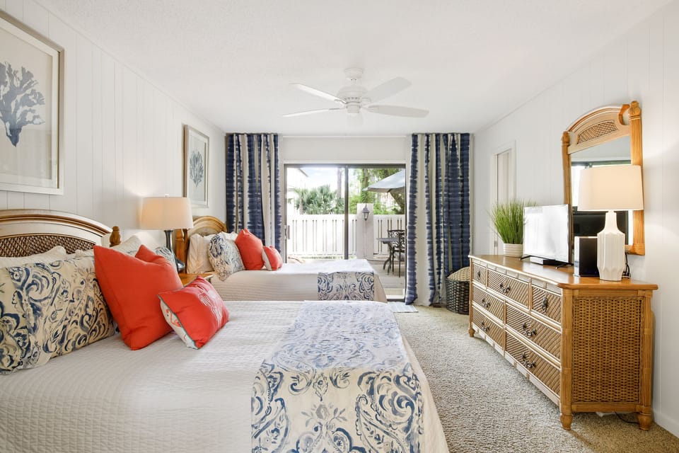 Two Full Size Beds overlooking the Front Deck with Fire Pit and Outdoor Dining