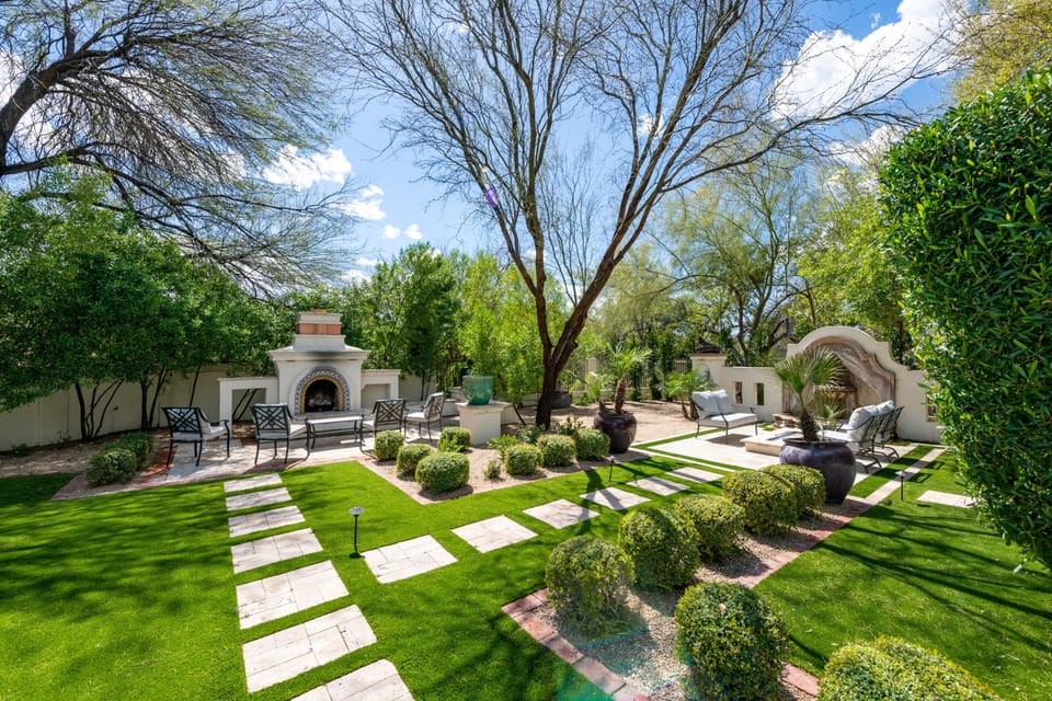 A backyard with a lush and enchanting view, offering a serene and relaxing retreat amidst verdant greenery.