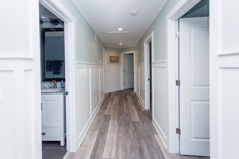 Hallway of the upstairs with 4 bedrooms and 3 full baths. 