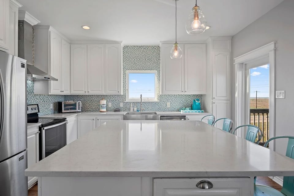 The kitchen island is a great meeting space to hang at while you cook.