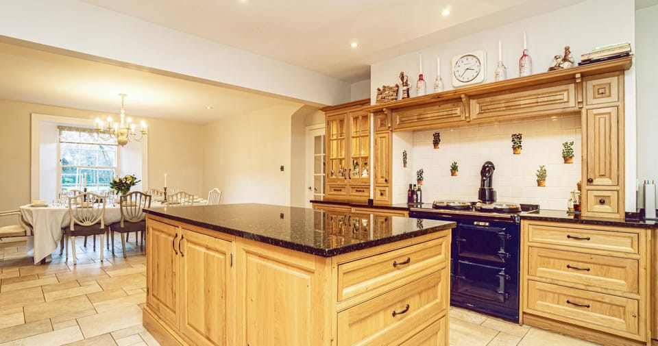Modern kitchen with an AGA cooker, and a dining table for 8 or extending to 10.