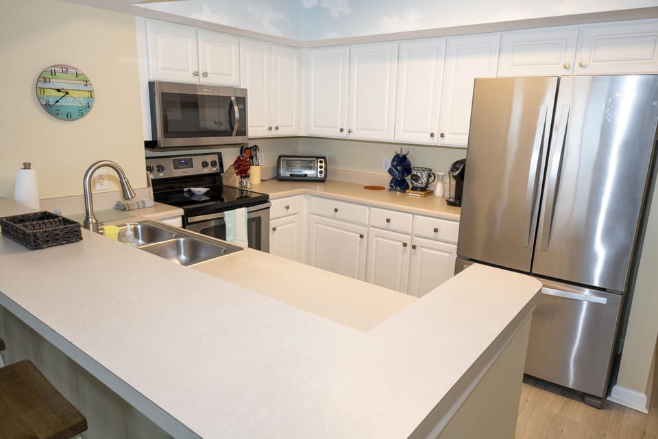 Kitchen is roomy and well stocked with everything you need