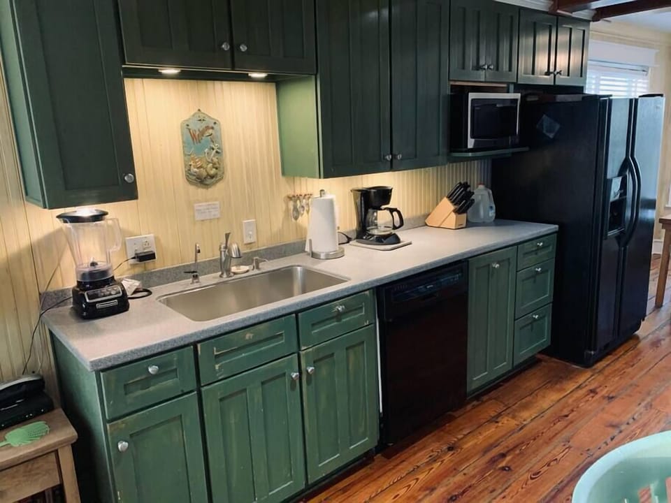 Fully equipped kitchen with deep stainless-steel sink and updated appliances 