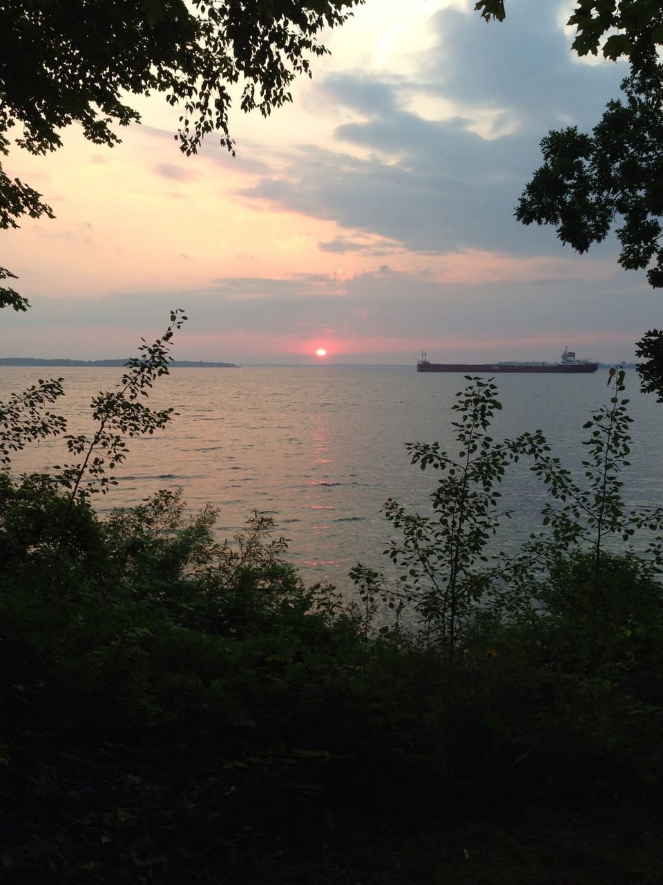 Passing freighter at sunset on the River